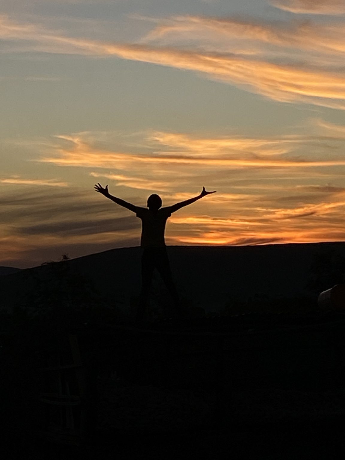 Beneath the golden African sunset, a child stands with arms wide open — a symbol of hope, strength, freedom, and the rising spirit of a generation ready to dream, grow, and shine.
